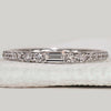 Baguette and round diamond band in white gold.
