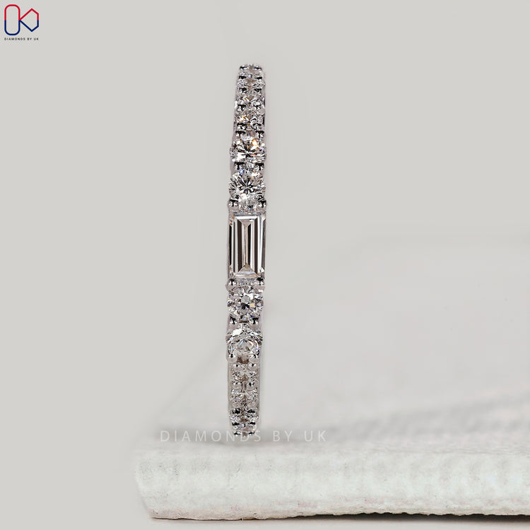Shared prong wedding band with baguette and round diamonds.
