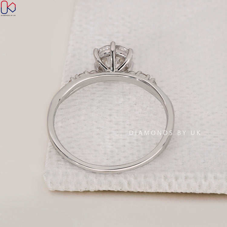 White gold ring with round center and side stones
