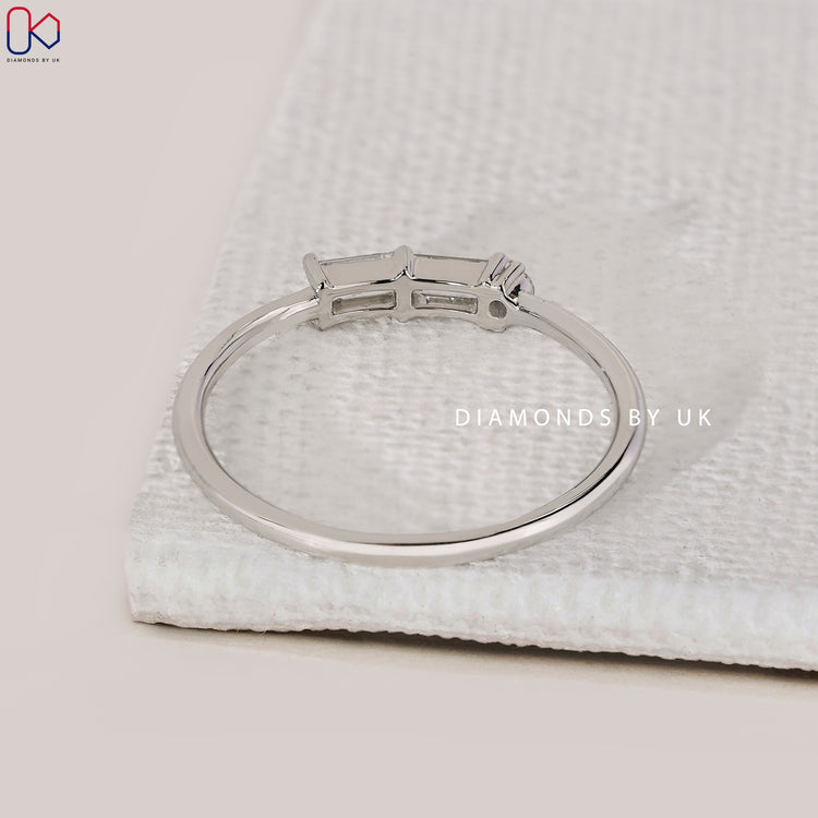 white gold Morse code wedding band with baguette diamonds.
