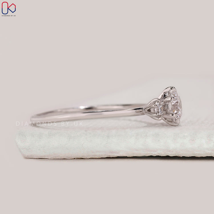 Round diamond ring with classic three stone style.
