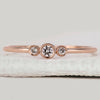 Bezel set round diamond band in rose gold.
