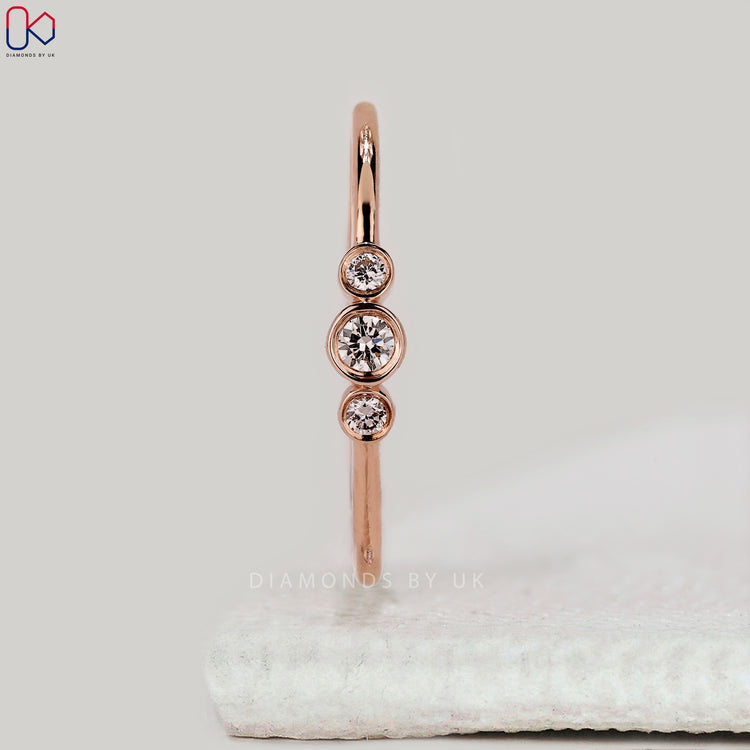 Custom rose gold 3 stone diamond wedding band.
