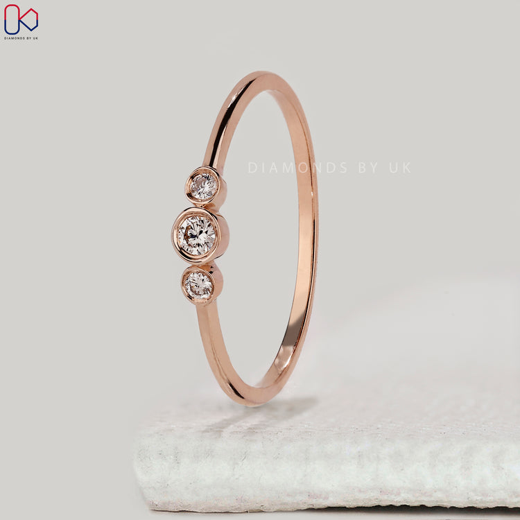 Dainty rose gold round diamond wedding band.
