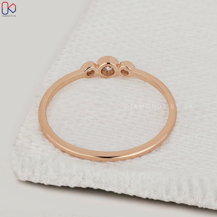 Diamondsbyuk rose gold bezel set diamond wedding band.
