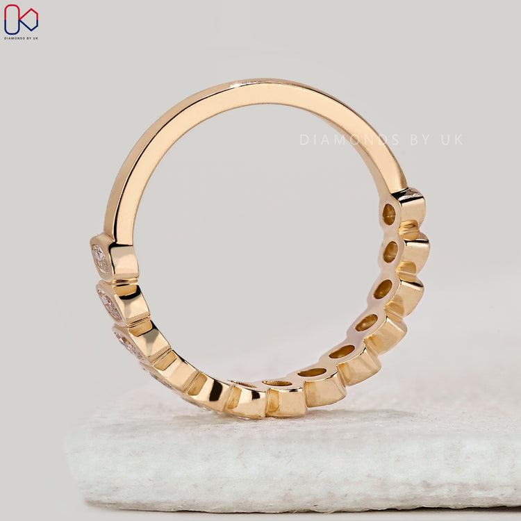 Buy yellow gold bezel set diamond band online.
