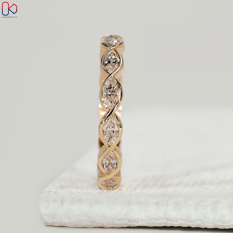 Yellow gold wedding band with marquise diamonds.
