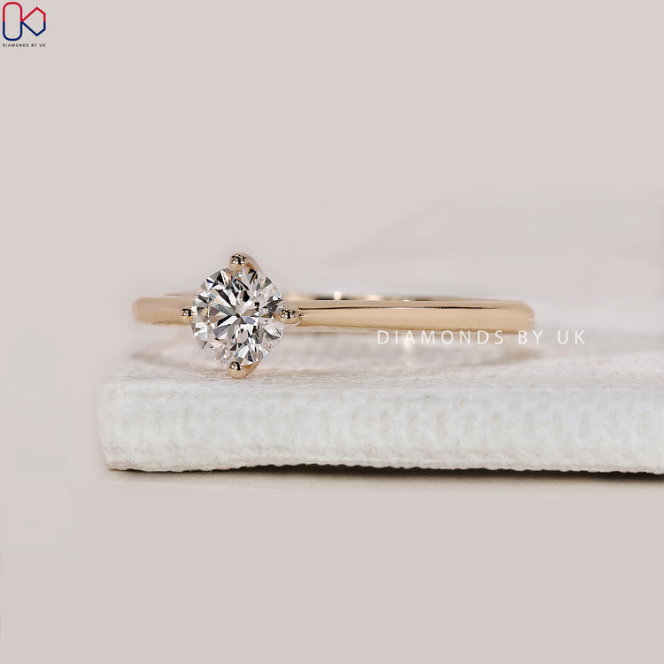 Yellow gold engagement ring with round cut stone.
