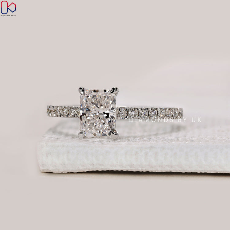 Cathedral setting ring with radiant cut center stone.
