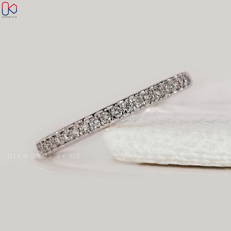 White gold wedding band with round diamonds.
