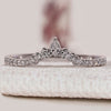 Pear and round cut wedding band with stackable style.