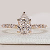 Pear cut ring with hidden halo and marquise pavé.