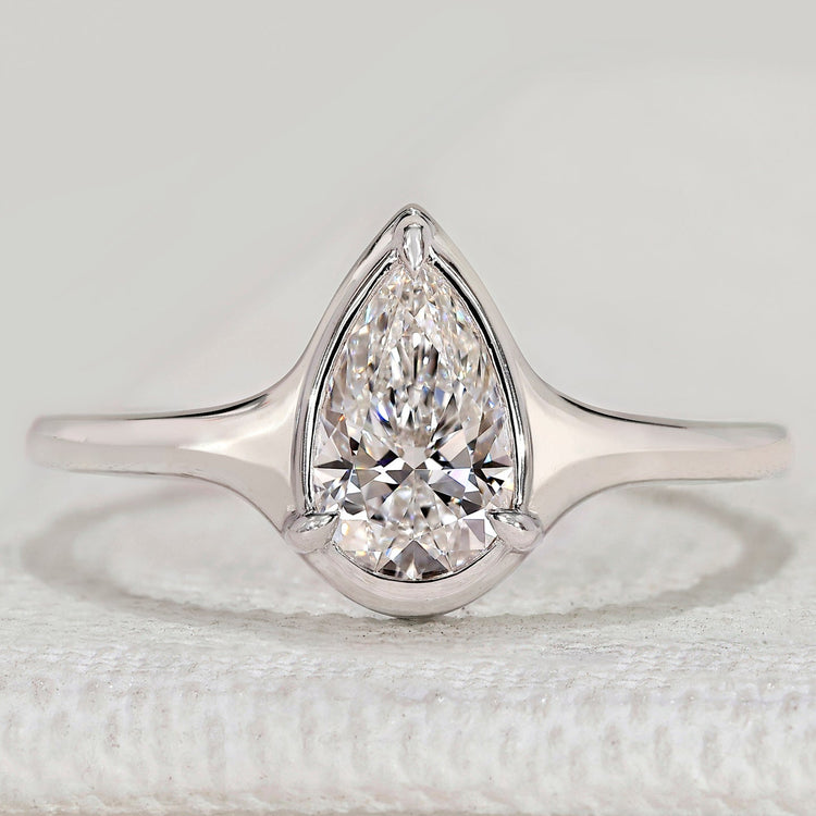 Pear cut solitaire ring with three prong bezel setting.
