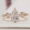Pear cut diamond ring with marquise and round side stones.
