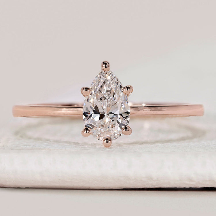 Pear cut solitaire ring with tapered shank design.