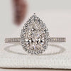 Pear diamond engagement ring with halo and pavé style.