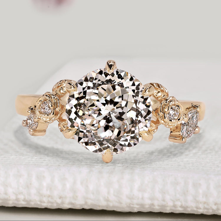 Portuguese cut diamond ring with marquise and round side stones
