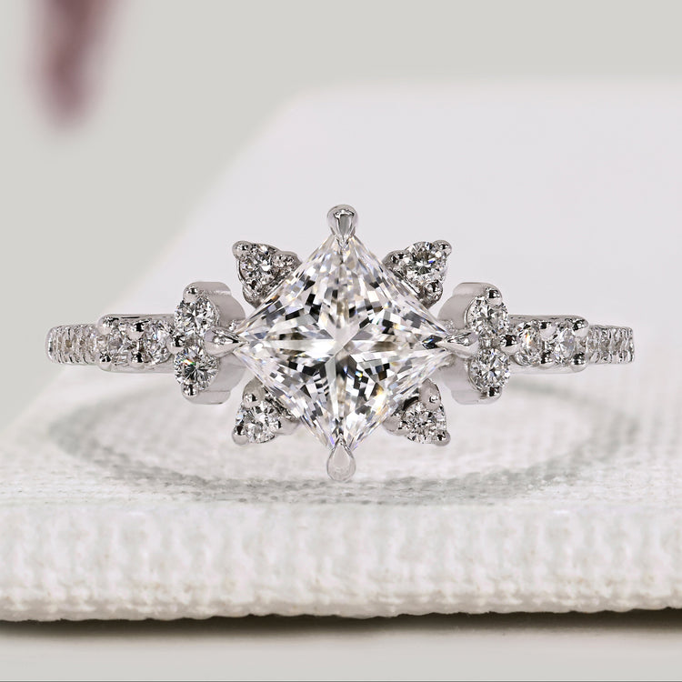 Princess cut diamond ring with round diamond pavé style.
