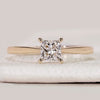 Princess cut solitaire ring with cathedral setting.