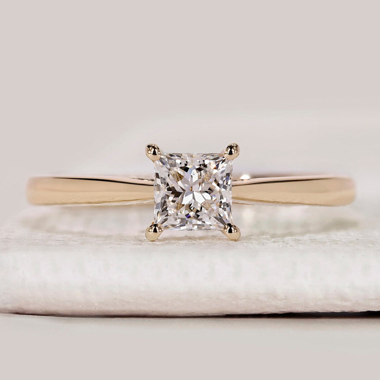 Princess cut solitaire ring with cathedral setting.