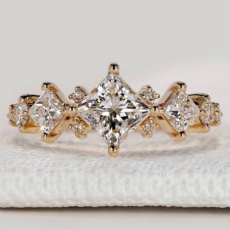 Princess cut ring with round and princess side stones.

