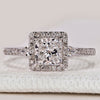 Princess cut ring with two pear side stones and halo.
