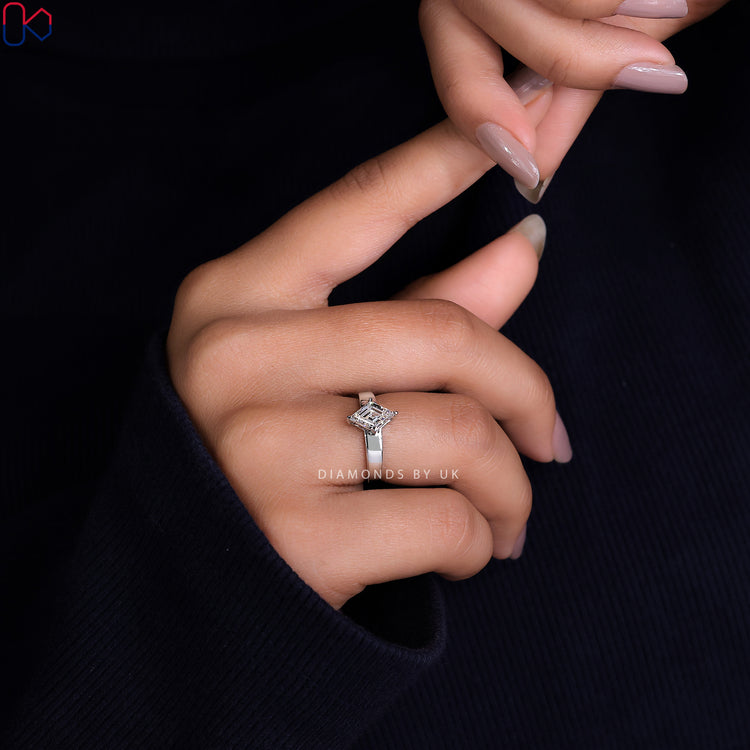Shop to buy engagement ring featuring a white gold band and lozenge cut diamond.