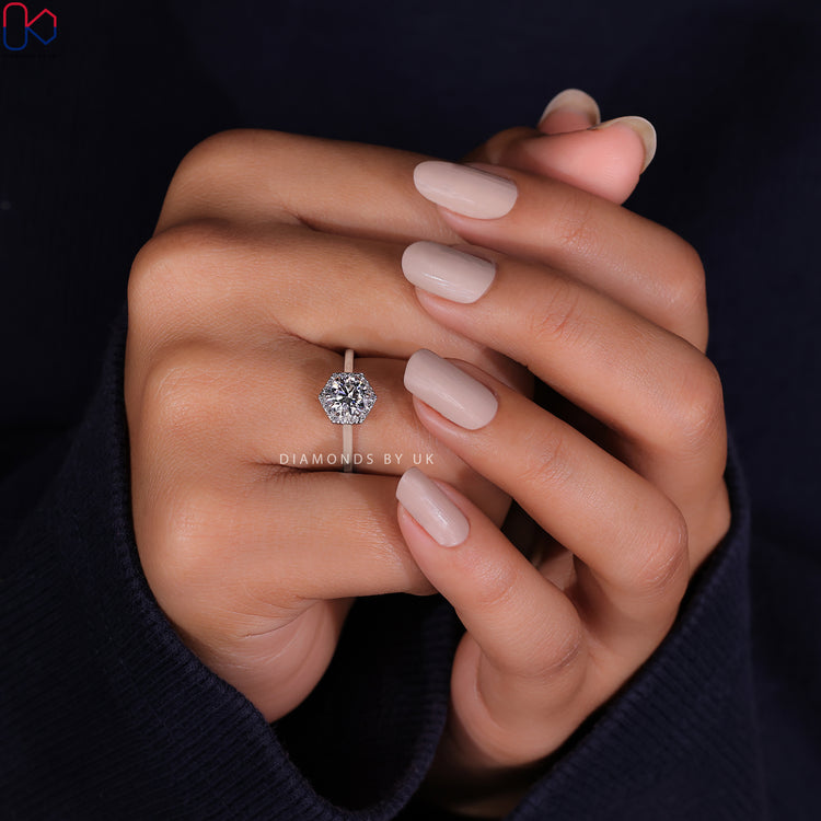 Shop to buy engagement ring with a round cut diamond and halo ring setting.
