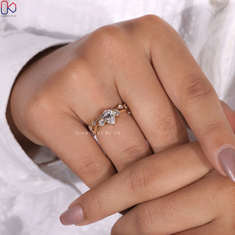 Bridal ring sets UK featuring a pear cut diamond and wedding band.
