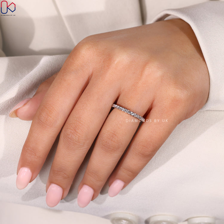 White and yellow gold wedding band with round cut diamonds.
