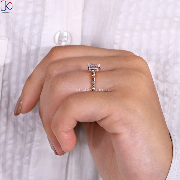 Rose gold engagement ring featuring a radiant center stone.
