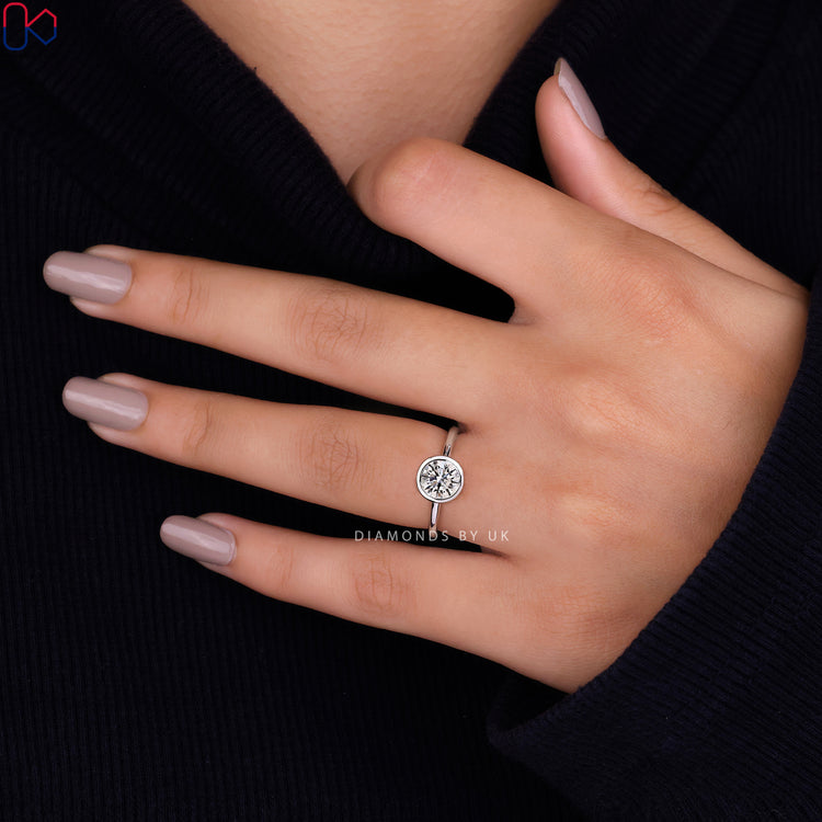 Engagement ring UK with a secure bezel setting ring and a beautiful round diamond engagement ring.