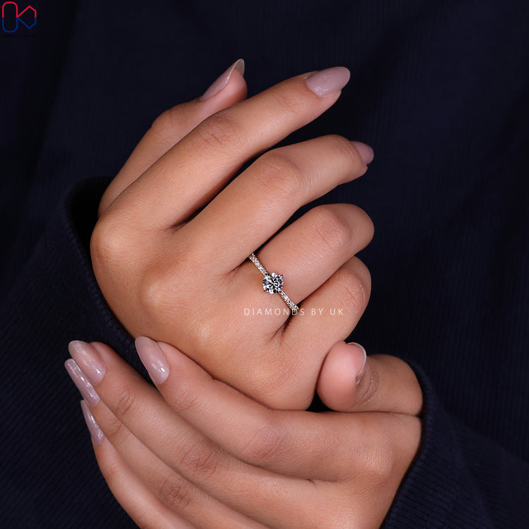 Diamondsbyuk ring featuring a stunning hidden halo engagement ring design.
