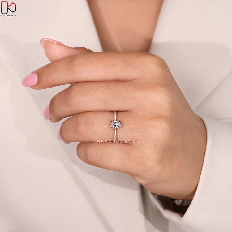 Buy Engagement Ring featuring an oval cut diamond in a white gold cathedral setting, perfect for any proposal.
