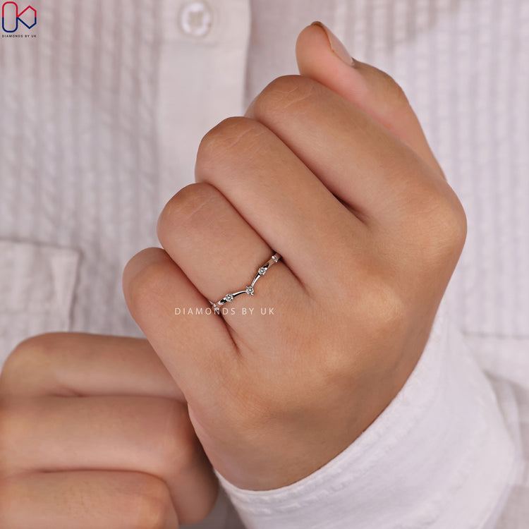 Round diamond wedding band offering timeless elegance and charm.