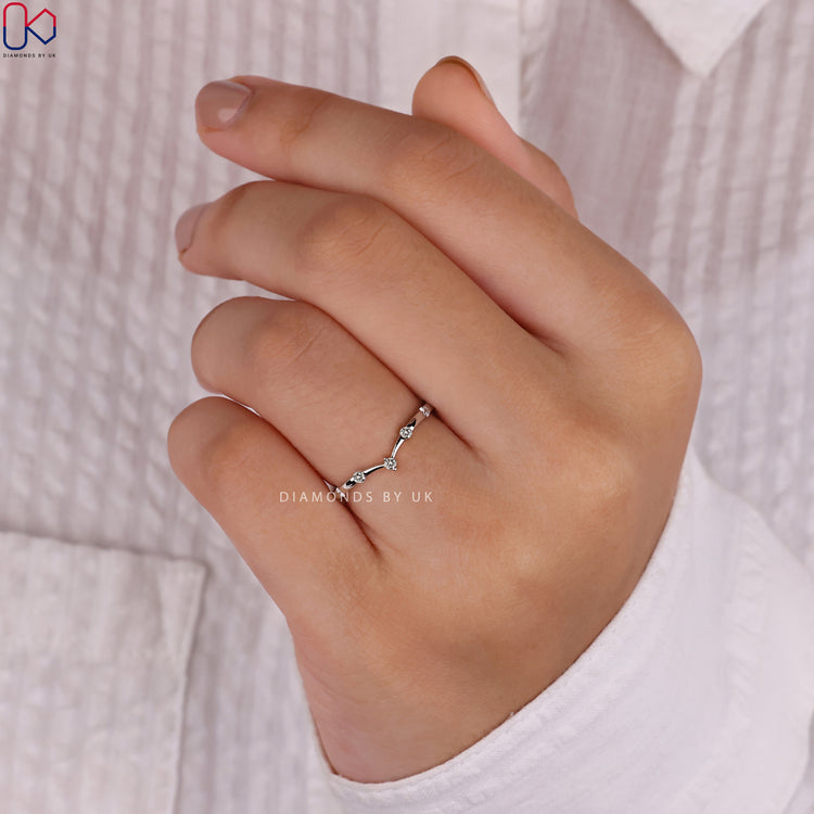 Prong set wedding band showcasing securely set brilliant diamonds.