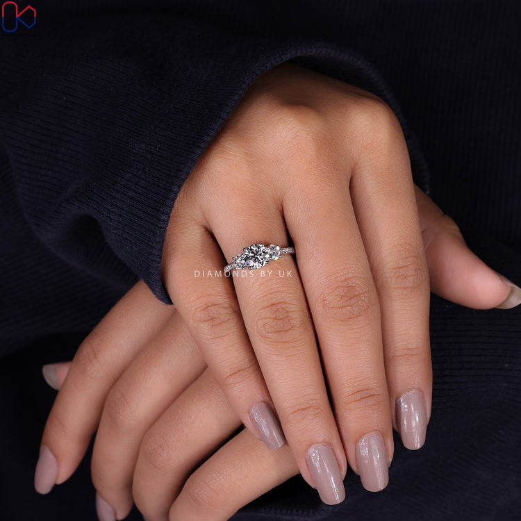 Handmade ring featuring three stunning diamonds in a trellis setting.