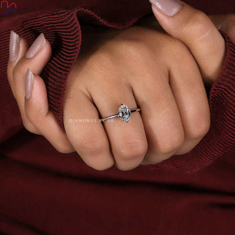 Oval cut diamond ring in compass prong setting.
