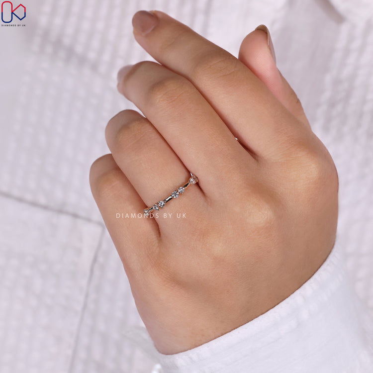 Half eternity band with round diamonds, crafted for lasting elegance.
