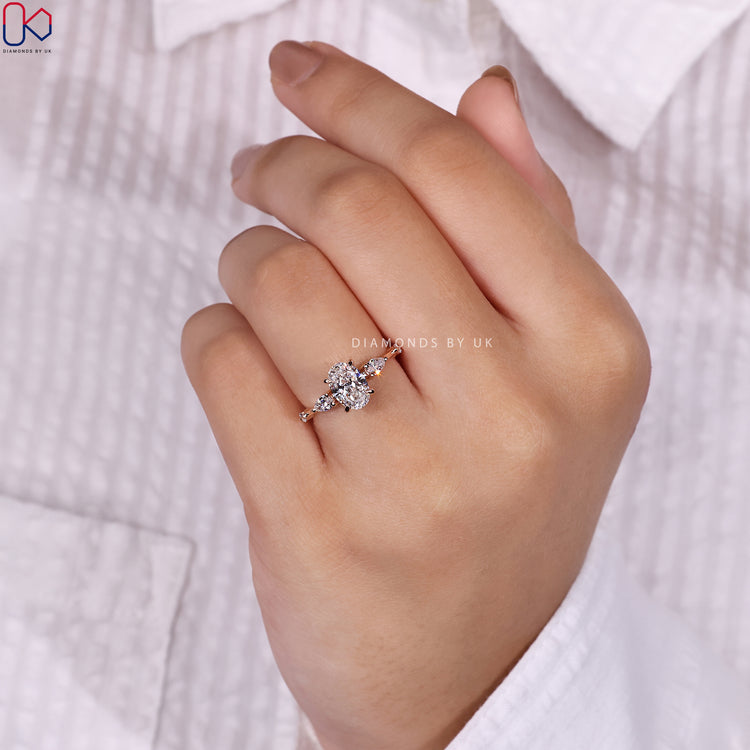 Pear and round diamond ring with a unique design.
