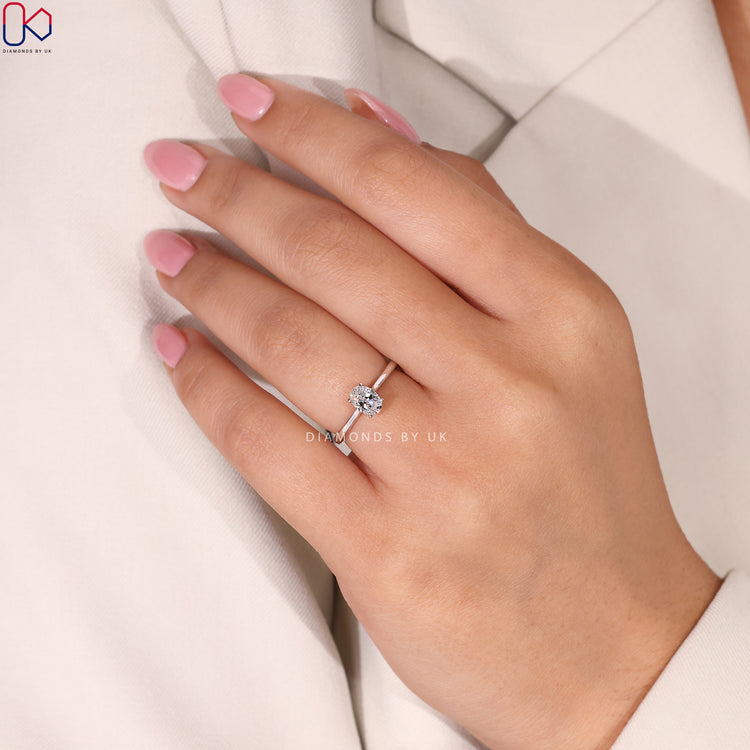 IGI Certified Oval Cut Diamond Ring in white gold, with a 4 prong claw setting and tapered shank.