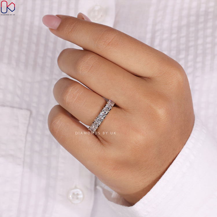 Yellow gold wedding band with a princess cut eternity design for classic style.
