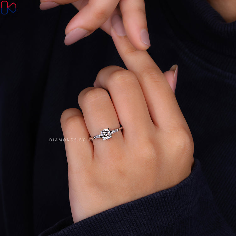 Round cut ring featuring a beautiful three stone engagement ring with diamonds.