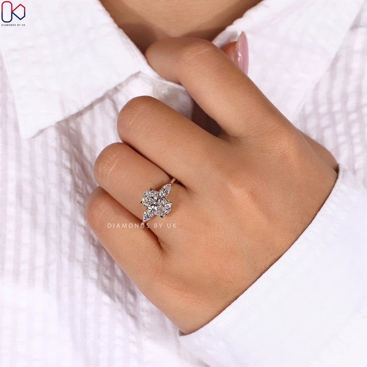 Oval ring with marquise side stones in a beautiful 3 stone diamond engagement ring design.
