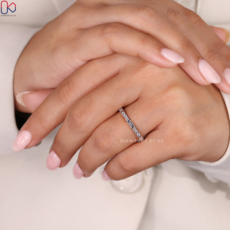 White gold wedding band with round and baguette diamonds.
