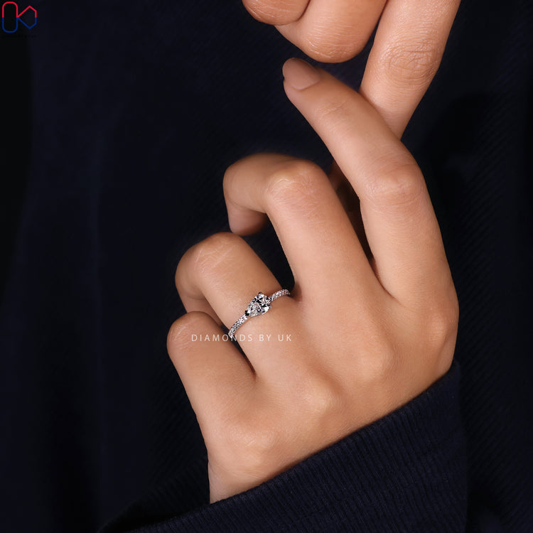 Handmade ring with pear cut and round pave accents.
