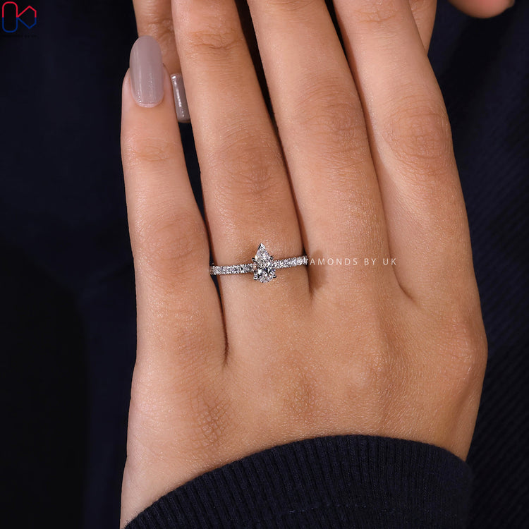 Customize ring with pear shaped diamond and pave shank.
