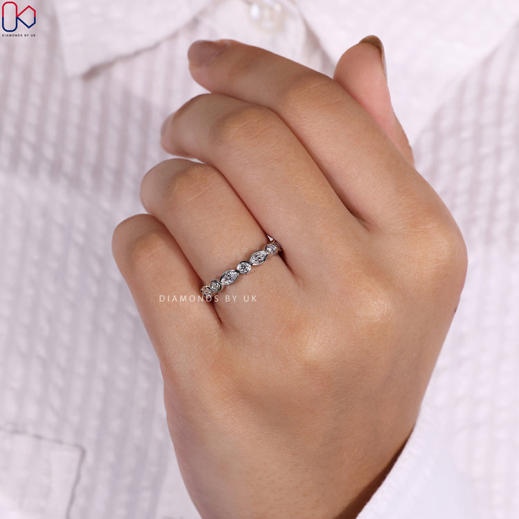 Bezel set eternity band with marquise diamonds for a secure and elegant fit.
