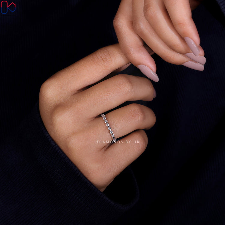 Prong setting diamond band ensuring secure and brilliant shine.
