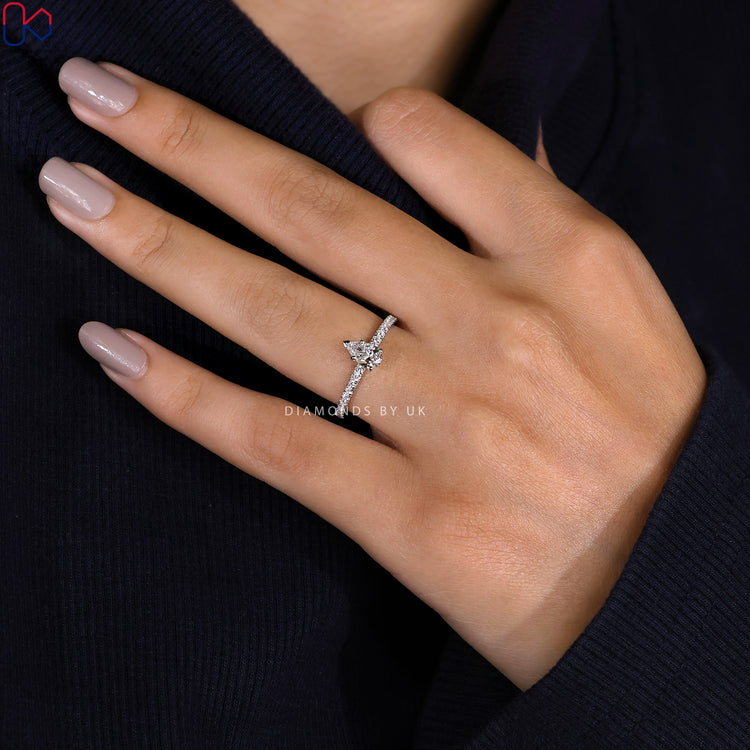 Handmade jewellery ring featuring pear shaped center stone.
